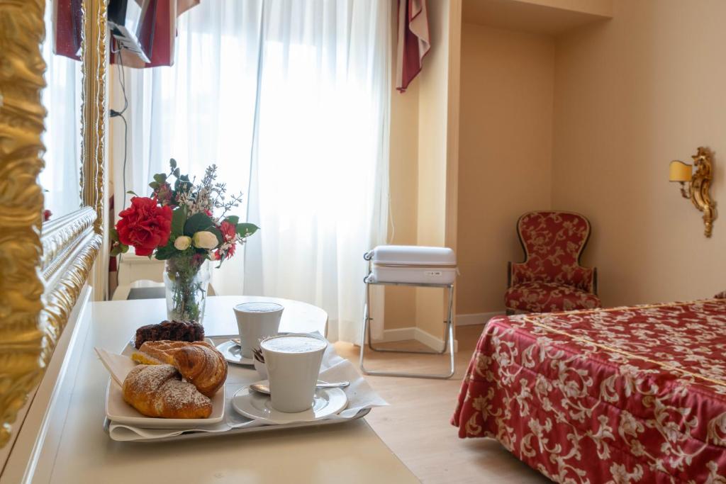 Postel nebo postele na pokoji v ubytování Hotel Manzoni Wellness&Spa