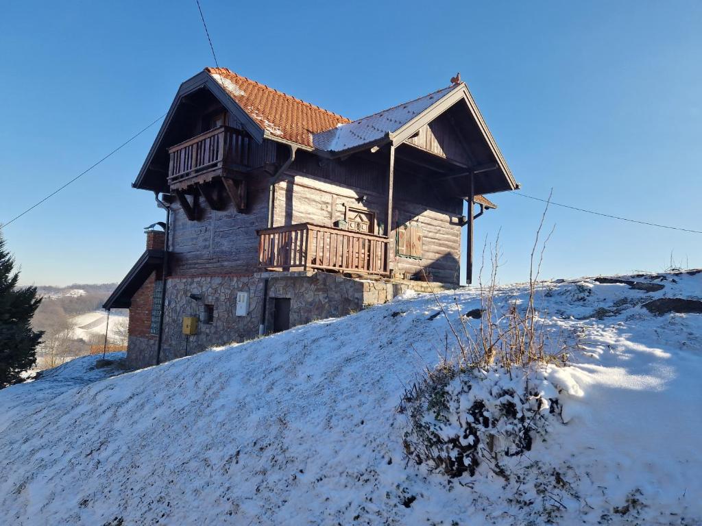 an old house on top of a snow covered hill at MareBob in Peršaves