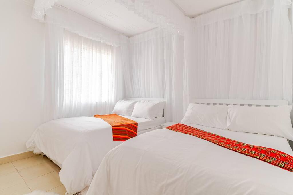 Postel nebo postele na pokoji v ubytování Saruni Homes