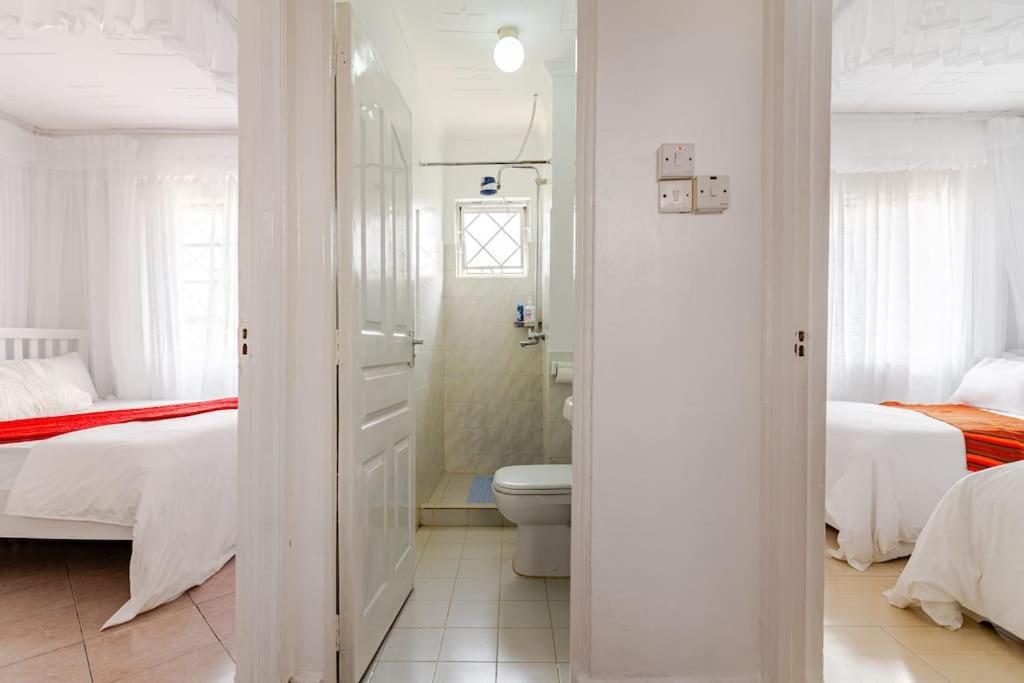 Postel nebo postele na pokoji v ubytování Saruni Homes