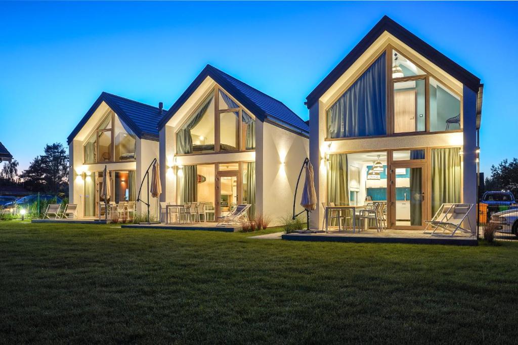 a large house with a lot of windows at Jesionowa 3 Domki in Rowy