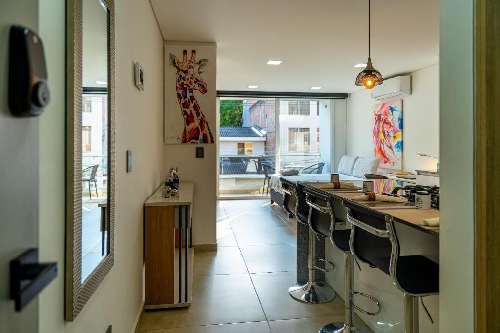 a room with a bar with chairs and a counter at 201 Norte cali - The View in Cali