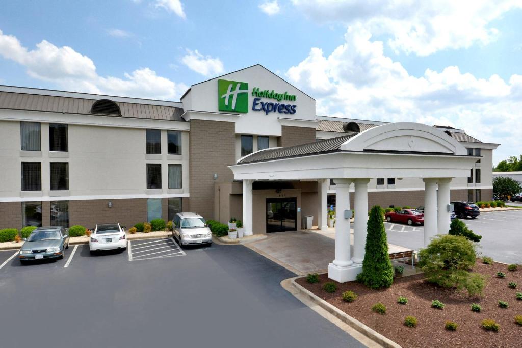 a hotel with cars parked in a parking lot at Holiday Inn Express Danville by IHG in Danville