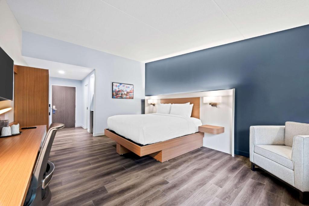 a hotel room with a bed and a chair at Best Western Niantic - New London, Mystic Area in Niantic