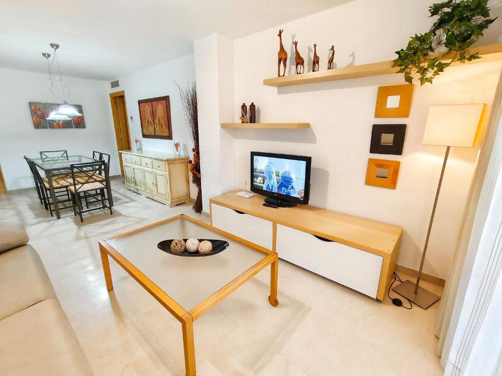 Televízia a/alebo spoločenská miestnosť v ubytovaní Vivienda en residencial con piscina