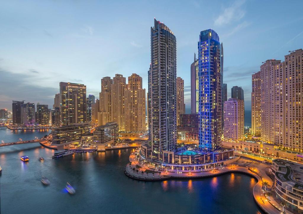 a view of a city at night with tall buildings at InterContinental Dubai Marina by IHG in Dubai