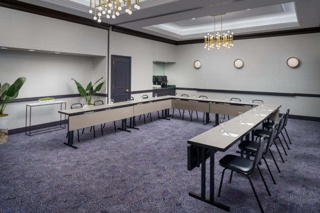 a conference room with tables and chairs and a chandelier at Courtyard New York Manhattan/Times Square in New York