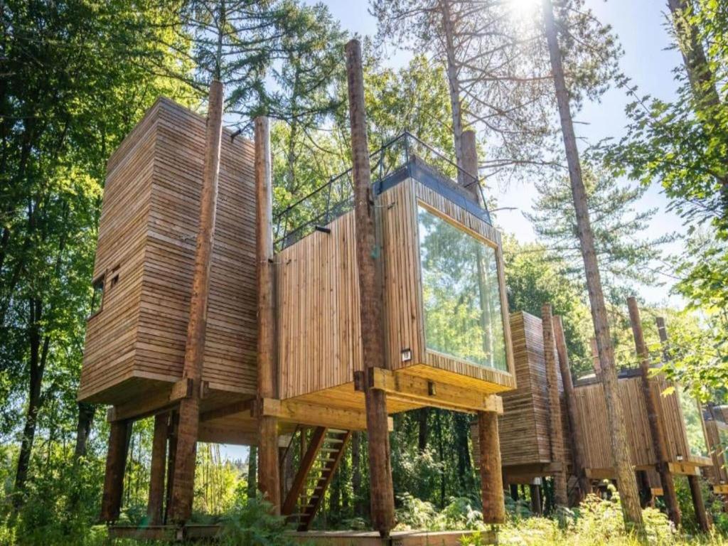 a tree house on wooden posts in the forest at Modern Antoing Home, Hainaut in Antoing