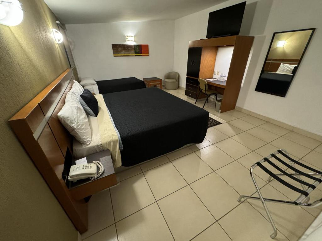 Postel nebo postele na pokoji v ubytování Hotel Interforum