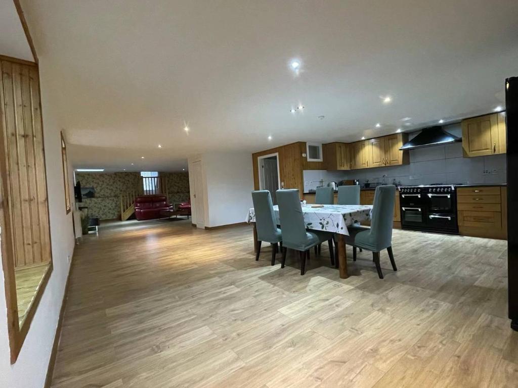 a kitchen and dining room with a table and chairs at Sunshine three bedrooms Apartment in Insch