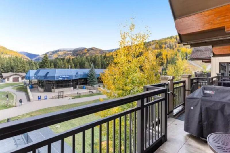 a balcony with a view of a park at Ski In, Ski Out 3 Bedroom Condo At The Eagle Bahn Gondola With Slopeside Pool in Vail