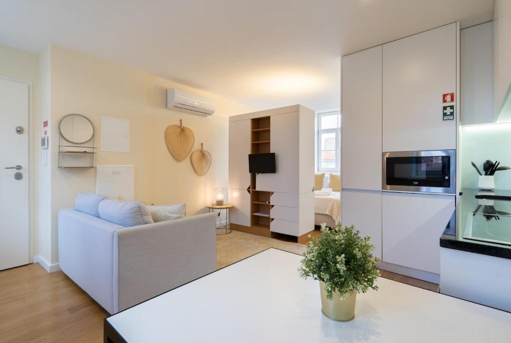 a living room with a couch and a table at Habitatio - Foz by LuxiStay in Porto