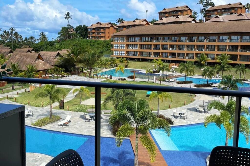 a view from a balcony of a resort with a pool at Eco Resort Praia Dos Carneiros - Vizinho a Igrejinha in Praia dos Carneiros