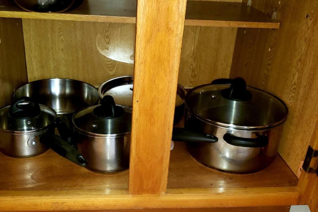 three pots and pans sitting on a shelf at Dominic Apt at Mt Hartman in Golflands