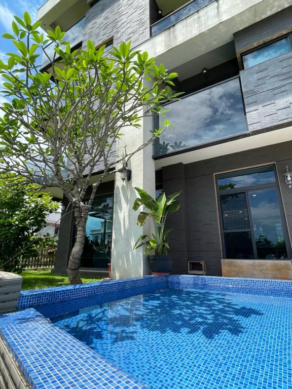 a swimming pool in front of a building at Rambling Snail in Luodong