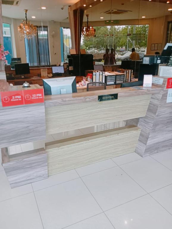 a counter in a store with wooden floors at Bluebell Hotel skudai in Kempas