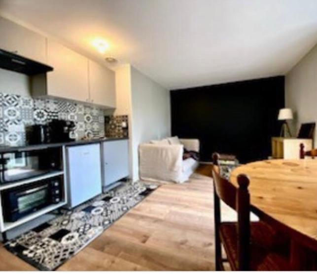 a kitchen with a table and a dining room at Saint Malo centre lambety in Saint Malo