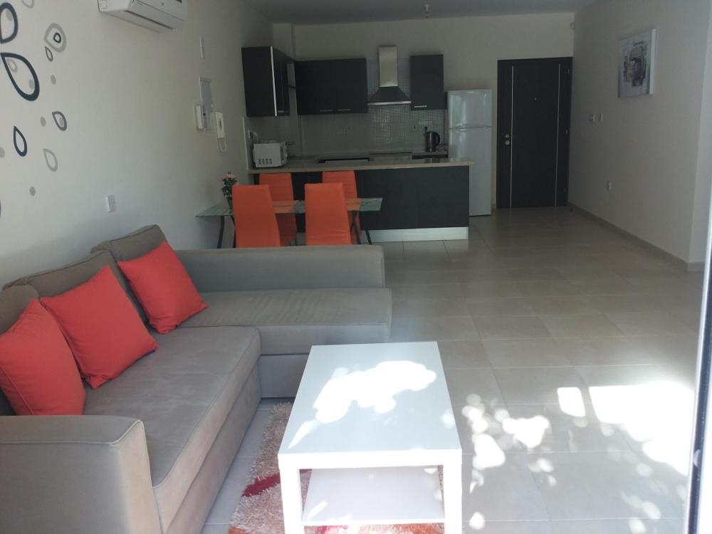 a living room with a couch and a table at Potamos Apartment in Limassol