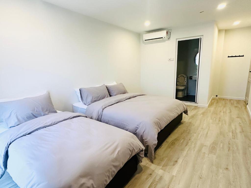 Postel nebo postele na pokoji v ubytování Cozii Home Marang