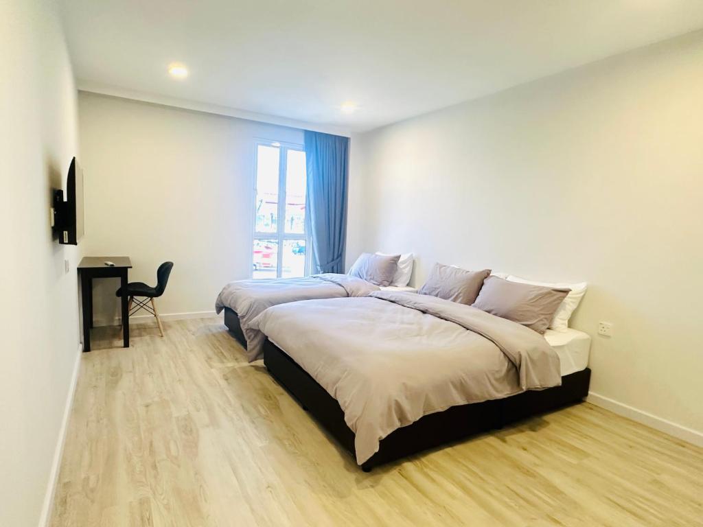 Postel nebo postele na pokoji v ubytování Cozii Home Marang