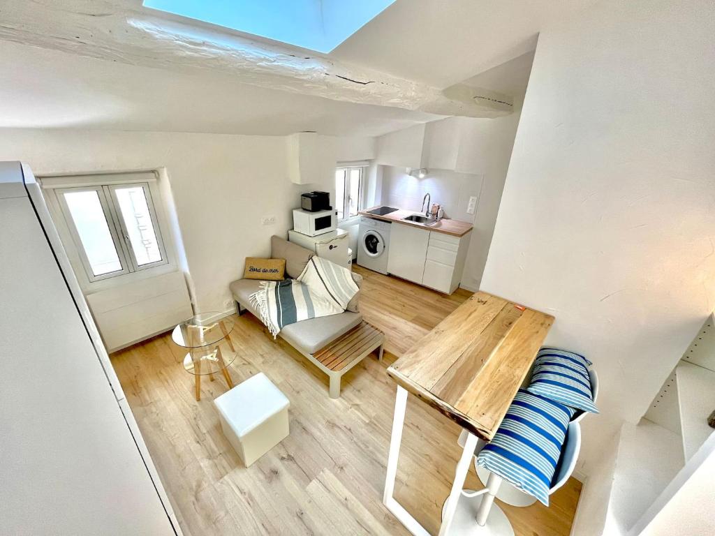 un petit salon avec un canapé et une table dans l'établissement « Studio Cosy vieille ville » refait à neuf, à Menton