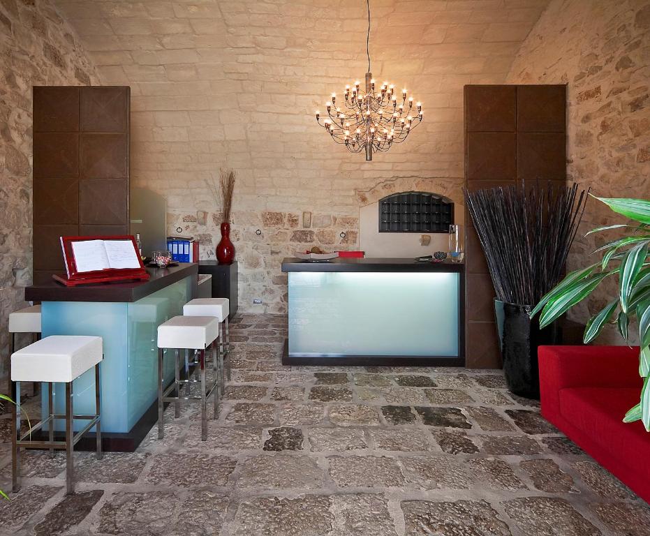 a bar with a counter and stools in a room at Casato Licitra in Donnafugata