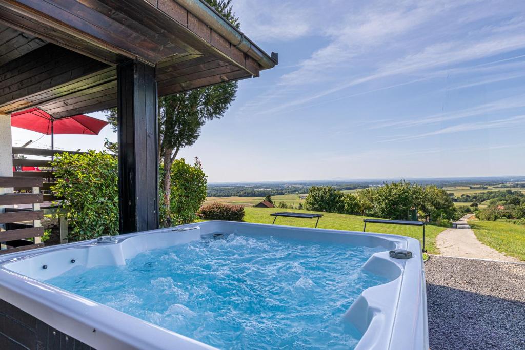 a hot tub on the side of a house at Holiday house VilAna with Jacuzzi - Happy Rentals in Puconci