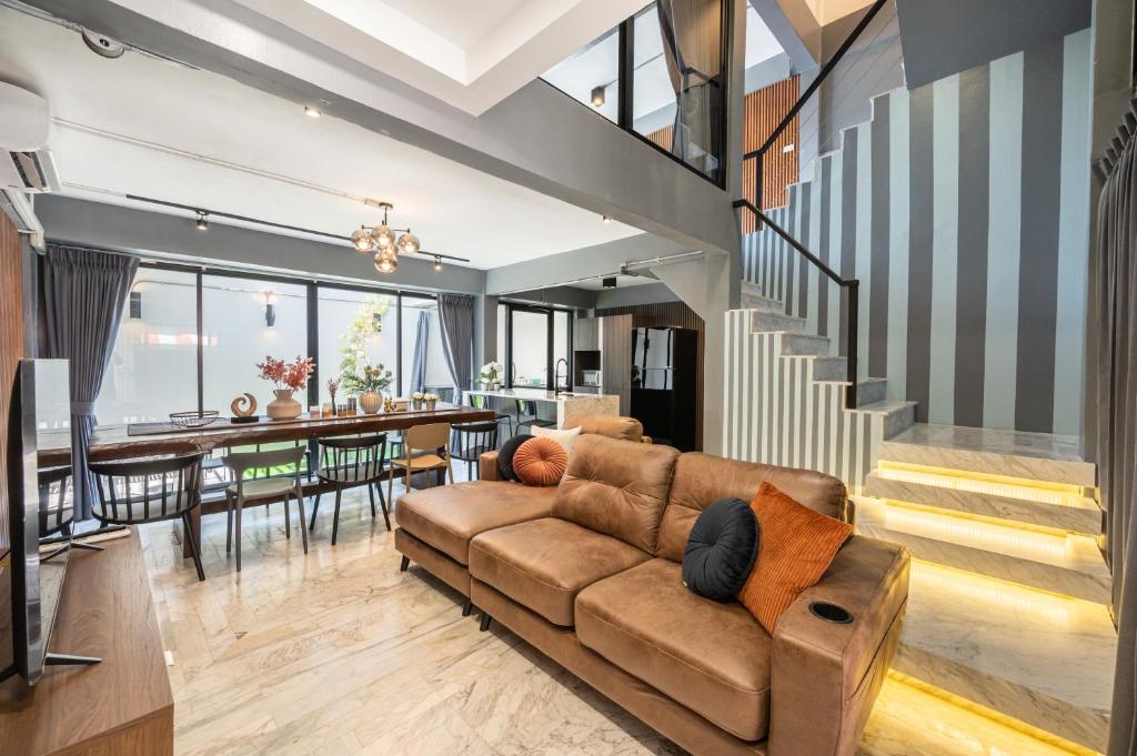 a living room with a couch and a dining room at S21 Mellow Phromphong in Bangkok