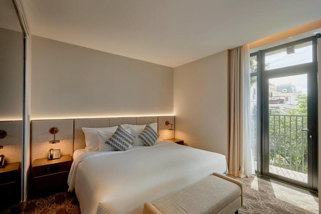 Postel nebo postele na pokoji v ubytování REY Hotel Hanoi