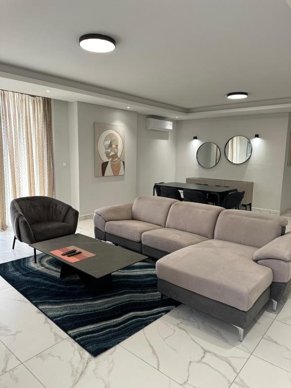 a living room with a couch and a piano at Luxury Furnished Appartments in Abidjan