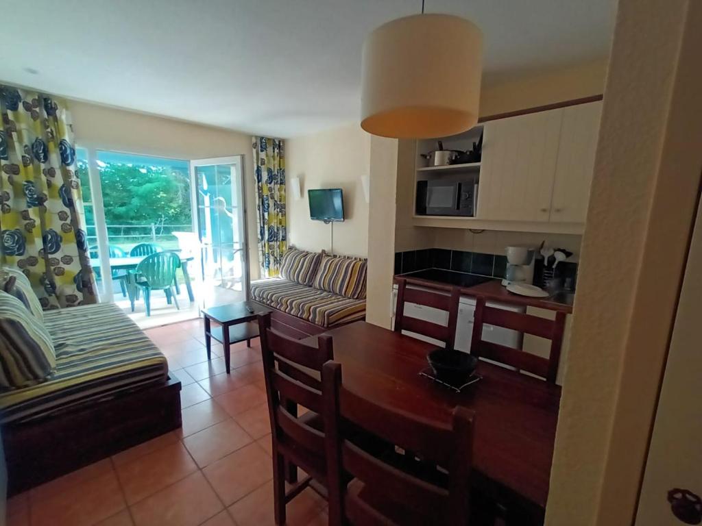 a living room with a couch and a table at Au pied de la Dordogne in Argentat