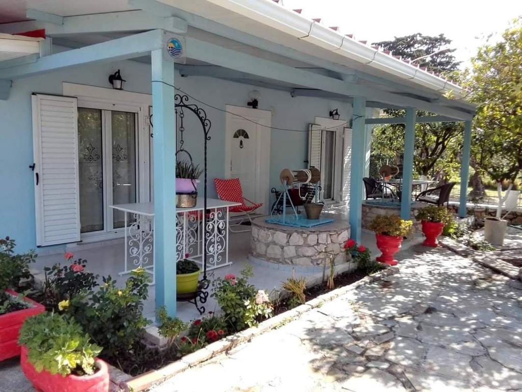 a porch of a house with a table and chairs at Villa Mimika in Vasilikos