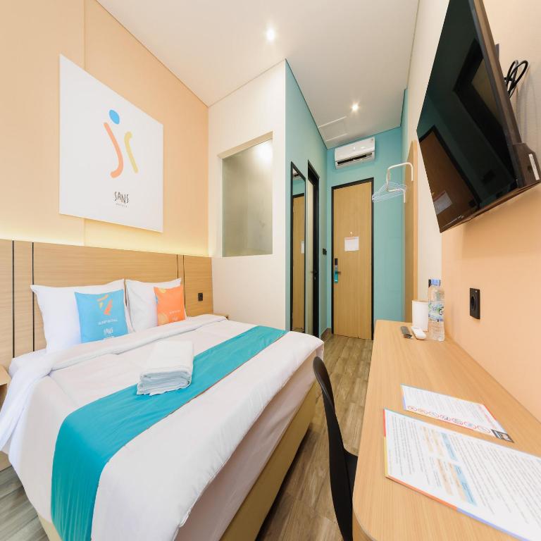 Postel nebo postele na pokoji v ubytování Sans Hotel Kedoya