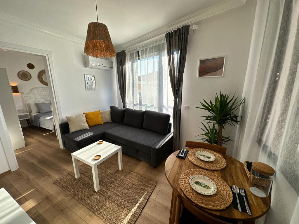 a living room with a couch and a table at House of spring in Çeşme
