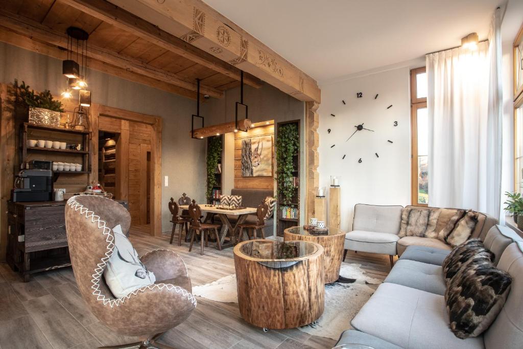 a living room with a couch and chairs and a table at Niedźwiedzia Residence Garden & Sauna in Poronin