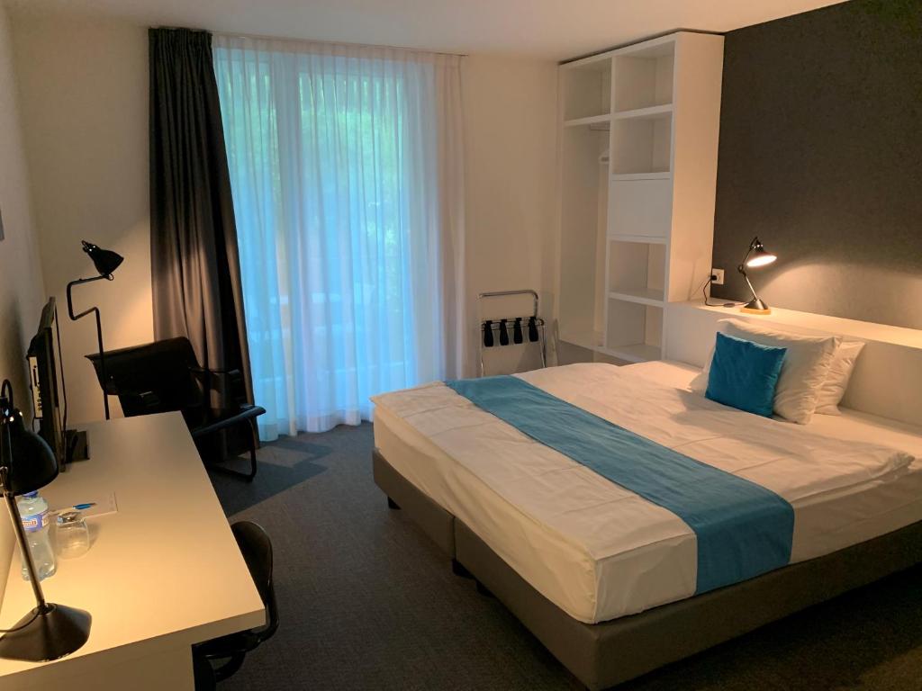 Voodi või voodid majutusasutuse Hôtel de la Source toas