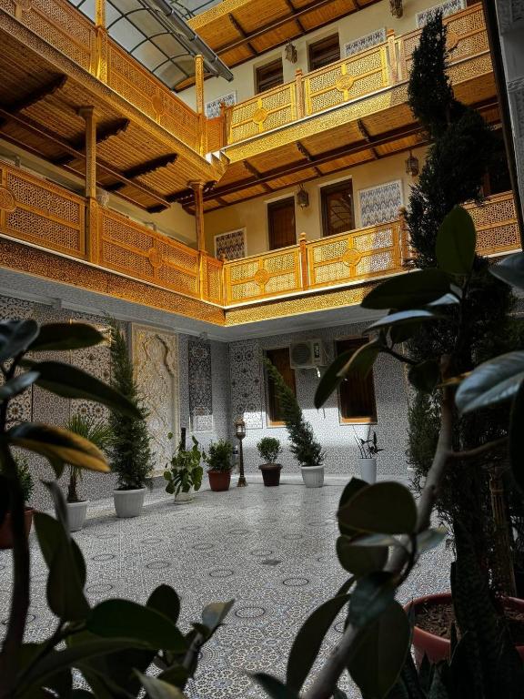 a large building with potted plants in a courtyard at Altair Boutique in Samarkand