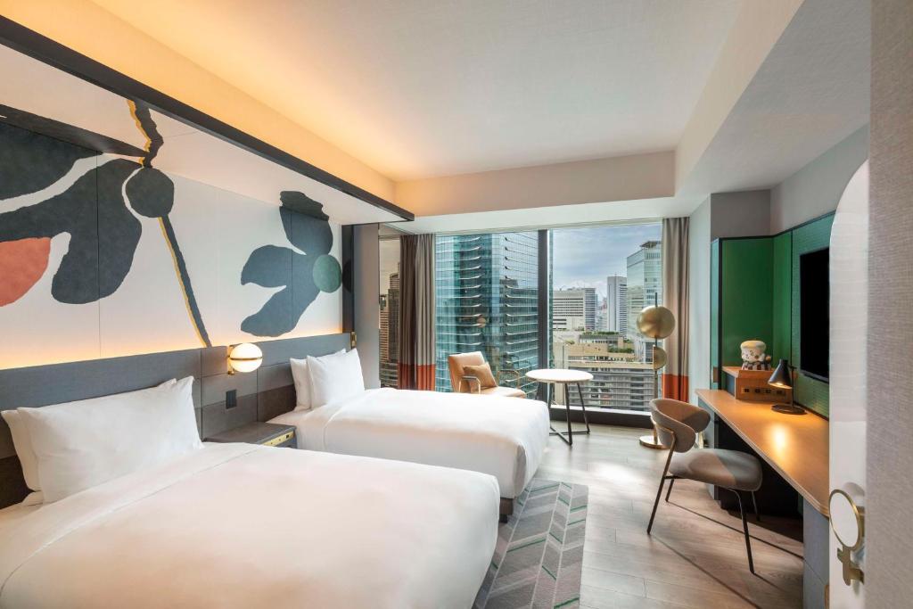 Postel nebo postele na pokoji v ubytování Canopy By Hilton Osaka Umeda