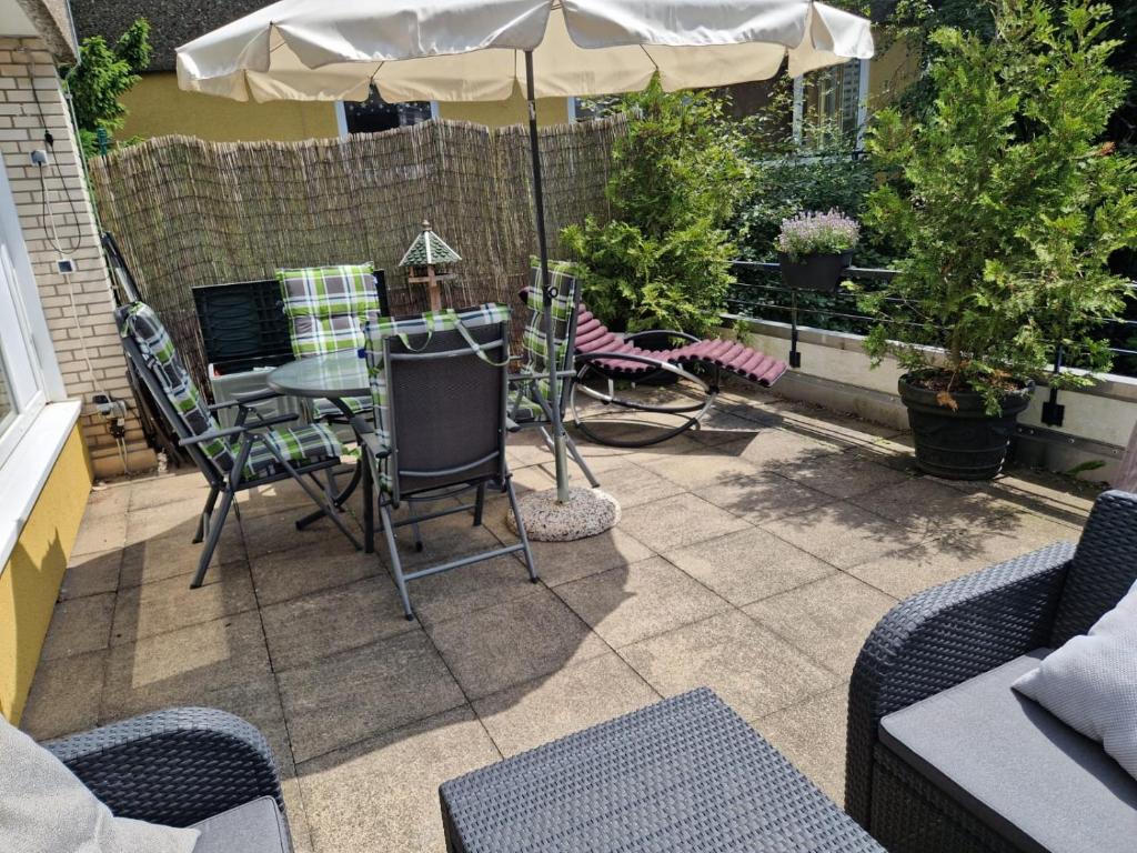 a patio with a table and an umbrella at Apartment am Rodelberg in Braunlage