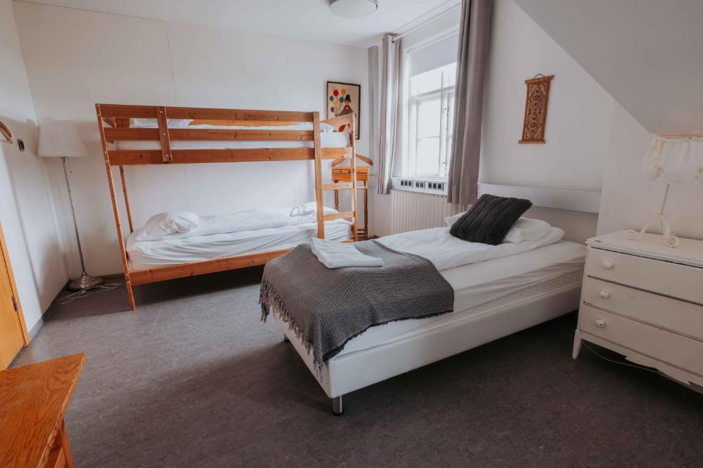 Voodi või voodid majutusasutuse Héradsskólinn Historic Guesthouse toas