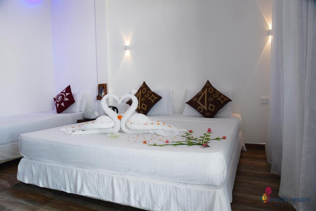 Postel nebo postele na pokoji v ubytování Dinuda Resort