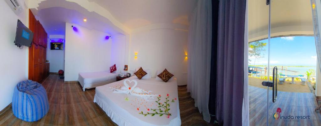 Postel nebo postele na pokoji v ubytování Dinuda Resort