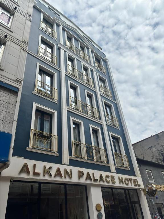 a blue building with a aliya palace hotel sign on it at Alkan Palace Hotel in Kesan