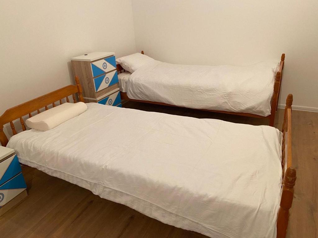 a room with two beds and a dresser in it at Dušanov konak in Vrbas
