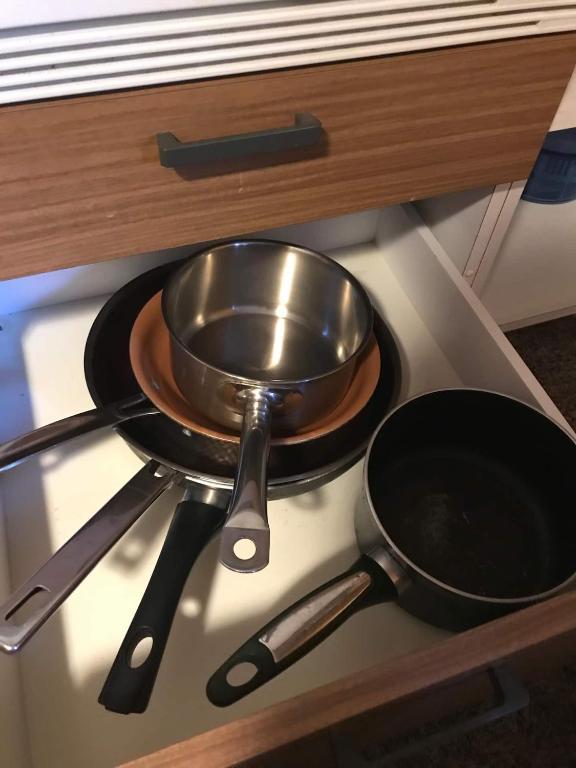 a pot and pans sitting on top of a stove at Vintage Apartment By Apartments Capricorn in Gsteigwiler