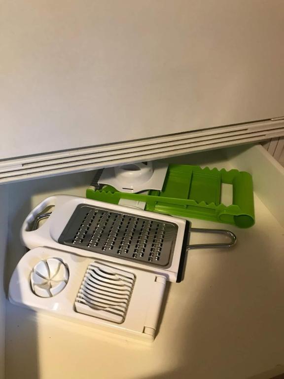 a green and white computer sitting on a desk at Vintage Apartment By Apartments Capricorn in Gsteigwiler