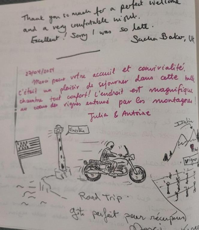 a piece of paper with a drawing of a man on a motorcycle at Chambre au coeur des vignes in Myans