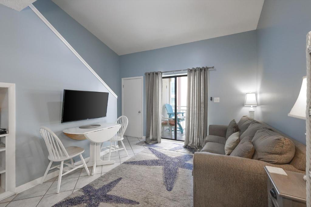 a living room with a couch and a table at Sugar Beach 353 in Gulf Shores