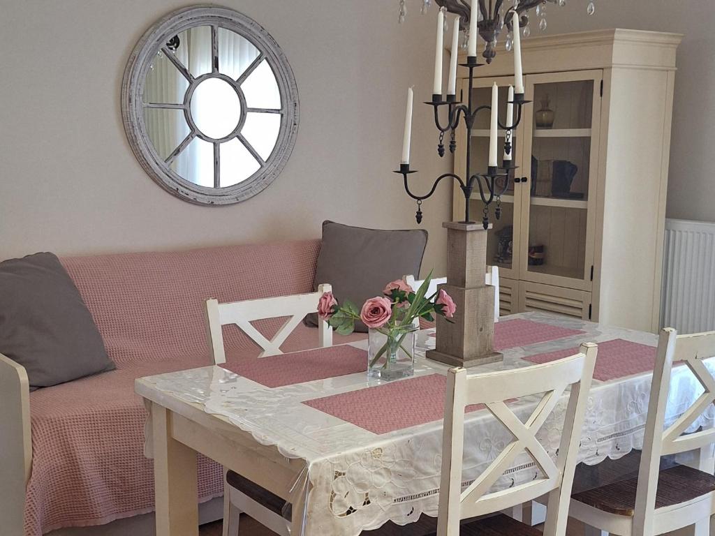a dining room with a table and a couch at Persefoni 's hause 1 in Nea Kallikrateia