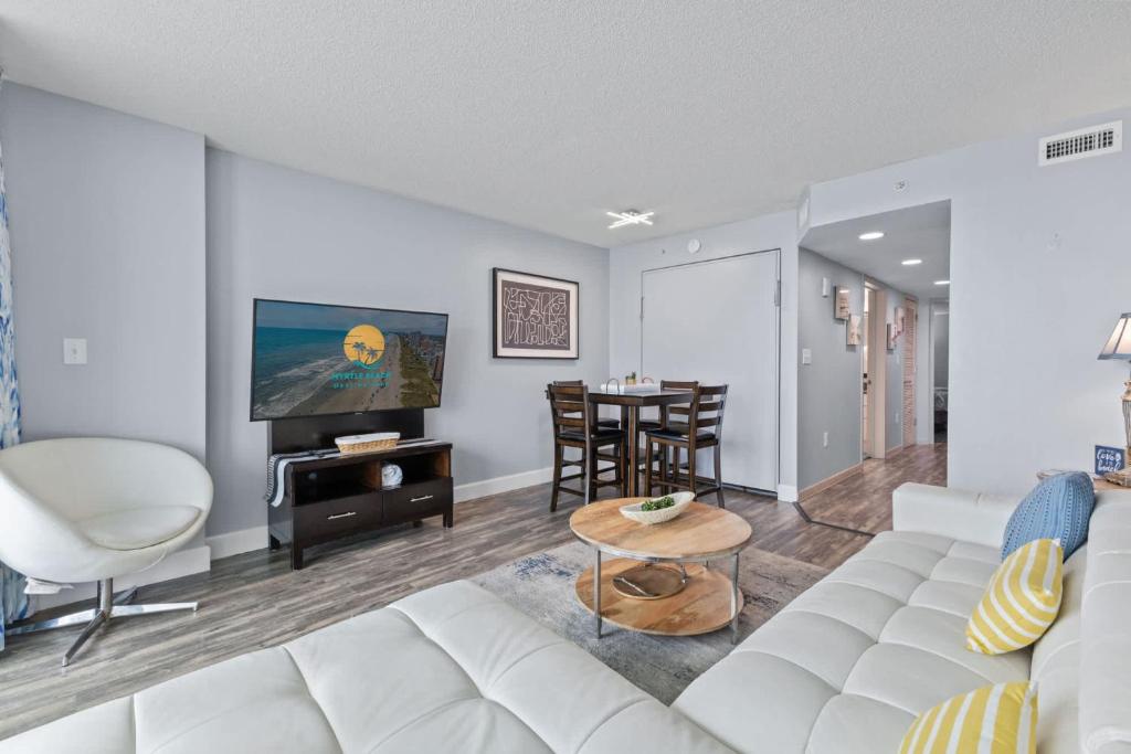 a living room with a white couch and a table at Oceans One Resort Unit 404 - Oceanfront in Myrtle Beach
